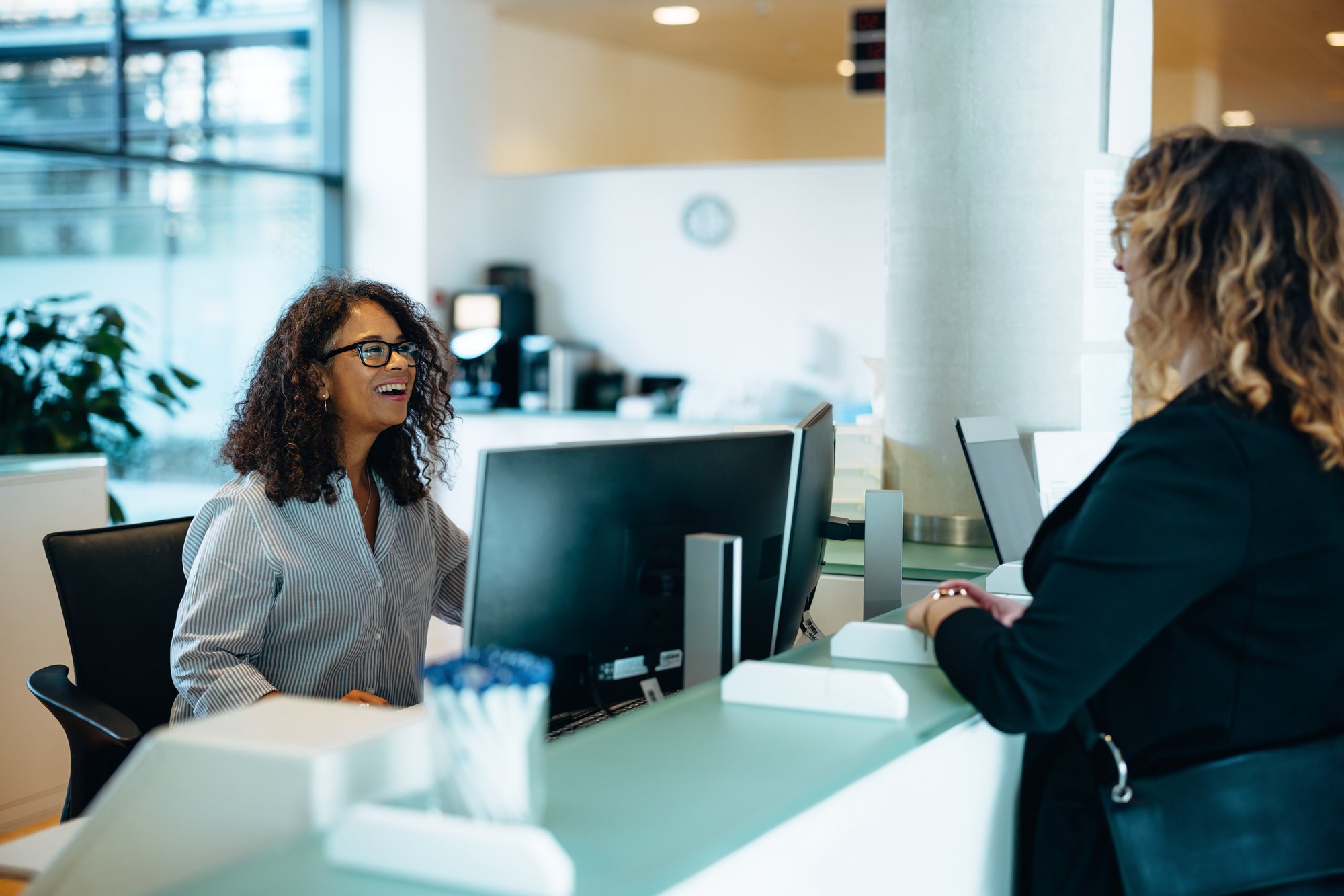 A receptionist helping a customer