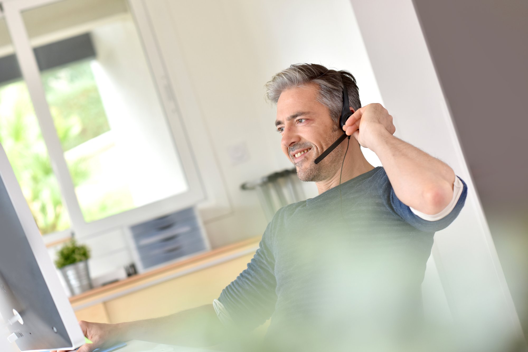 Businessman using headset in office