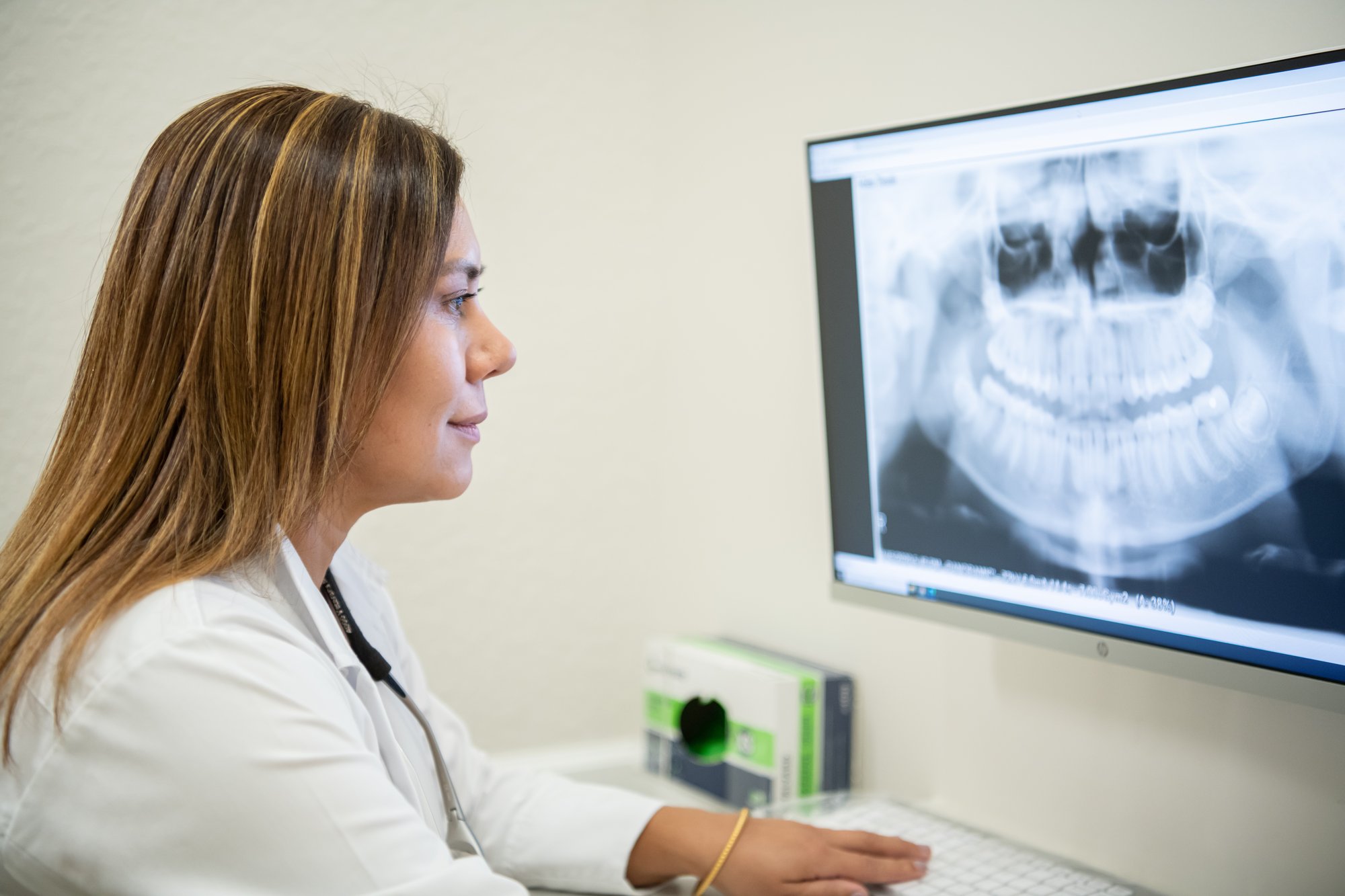 Dentist looking at xrays on computer