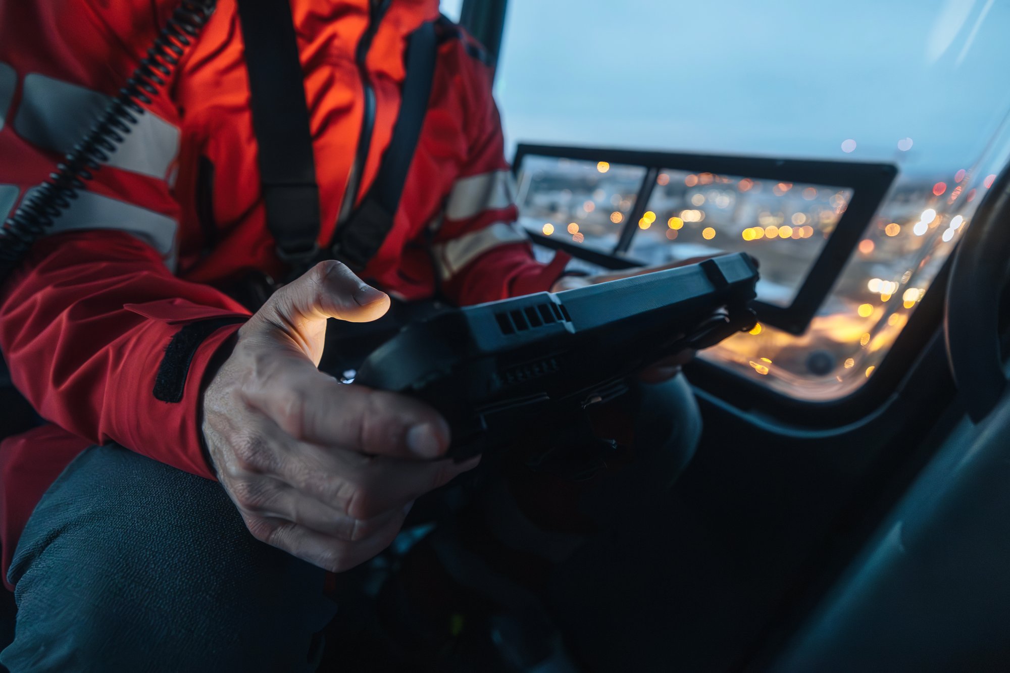 Doctor inside helicopter using tablet