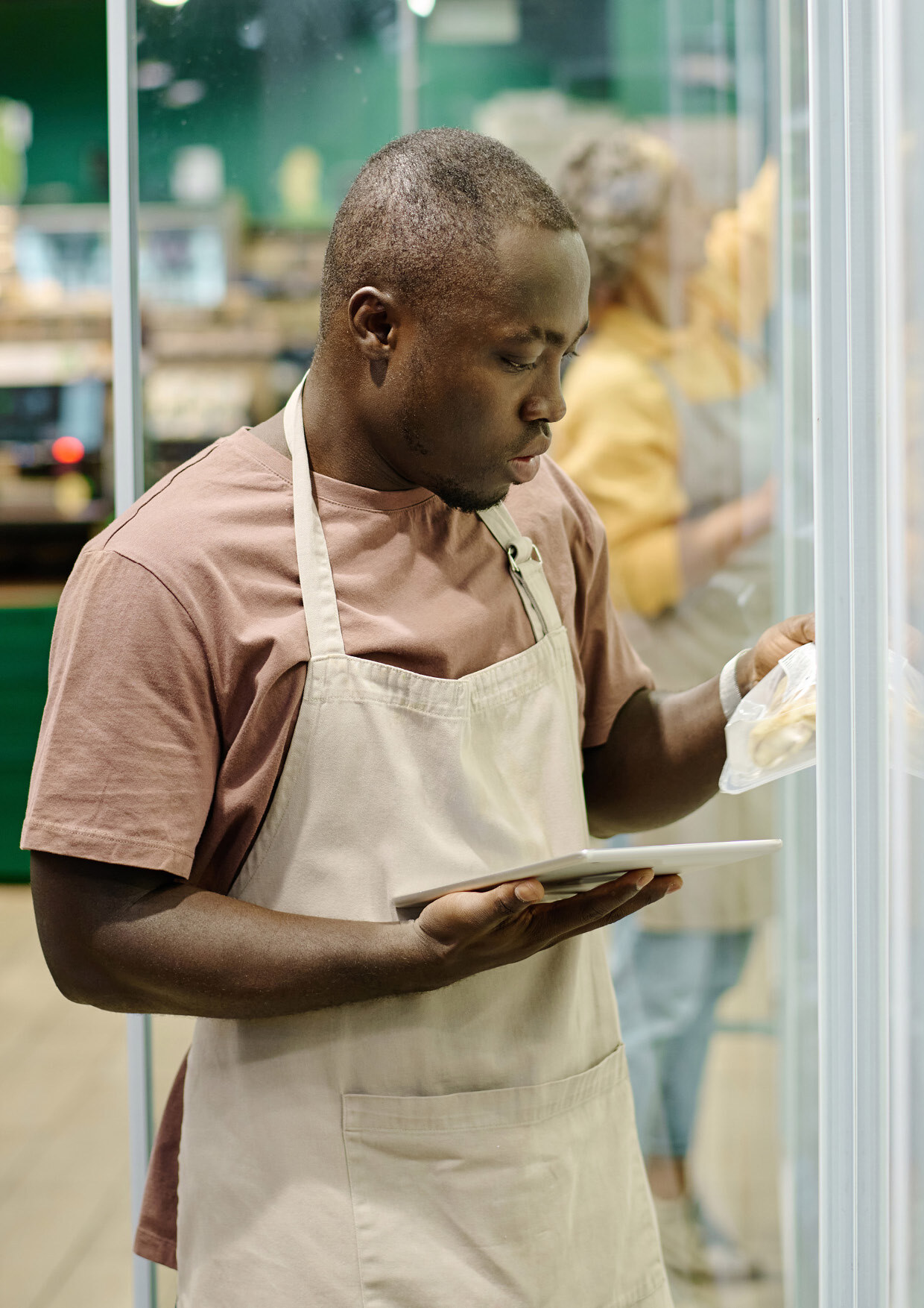 Grocery worker using tablet