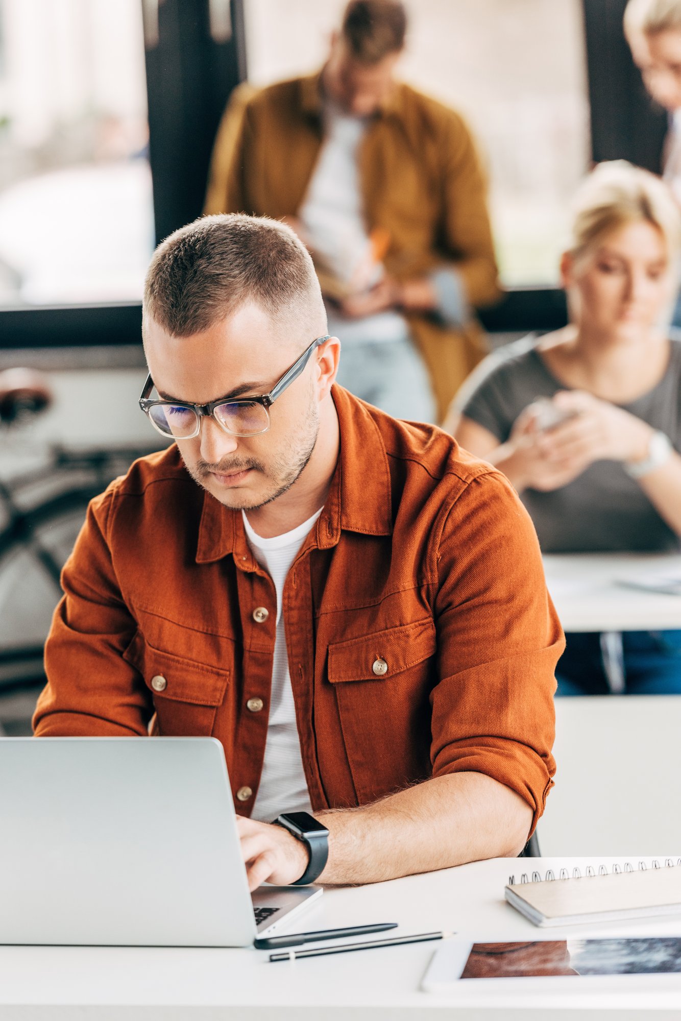 Man working on laptop at open office space