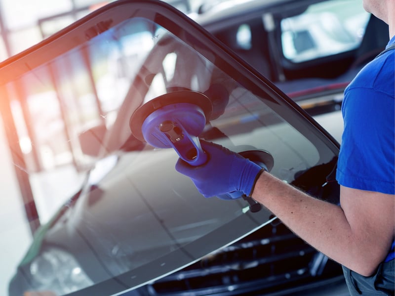 A worker installing a car window