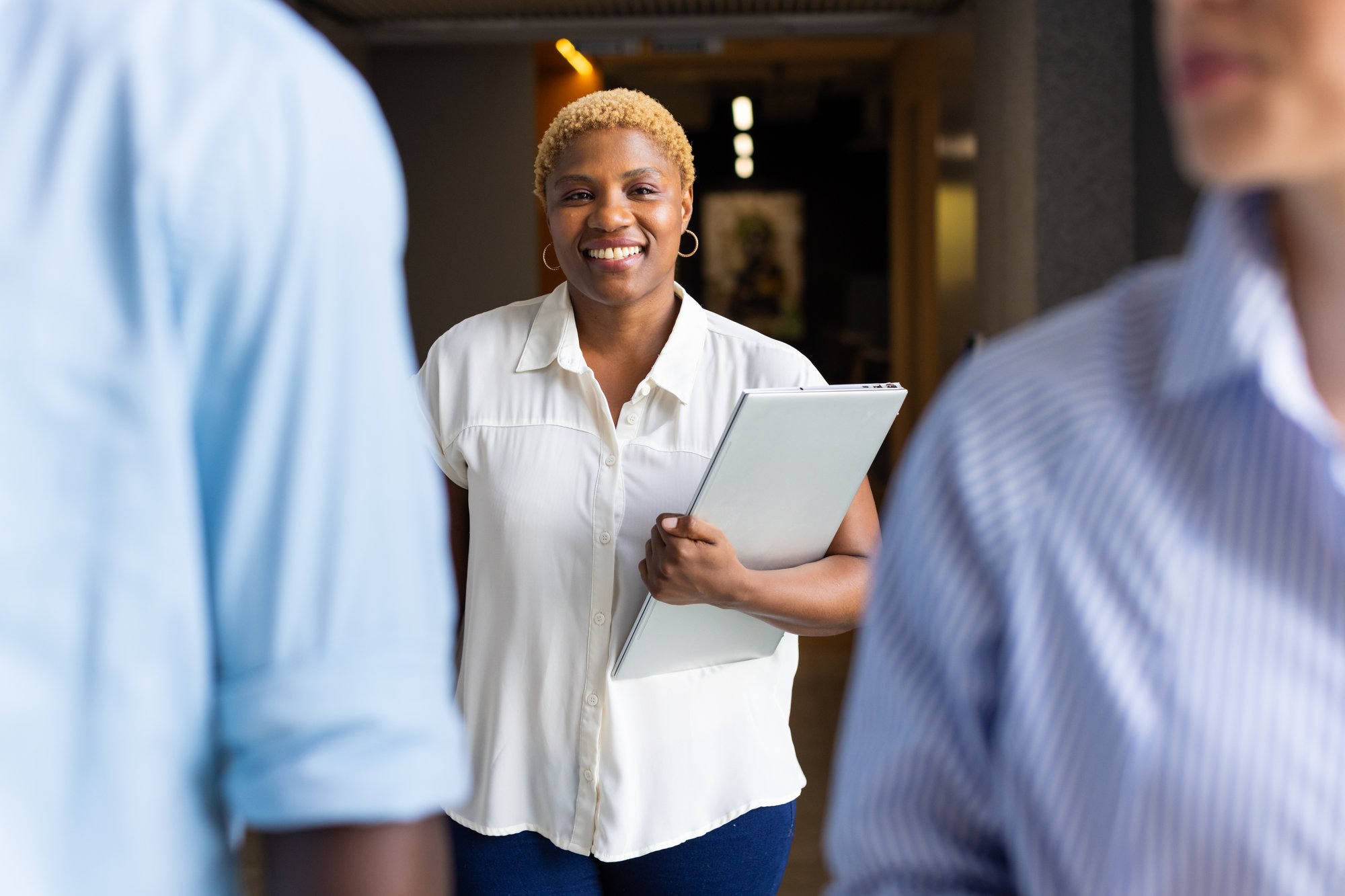 Woman holding laptop smiling